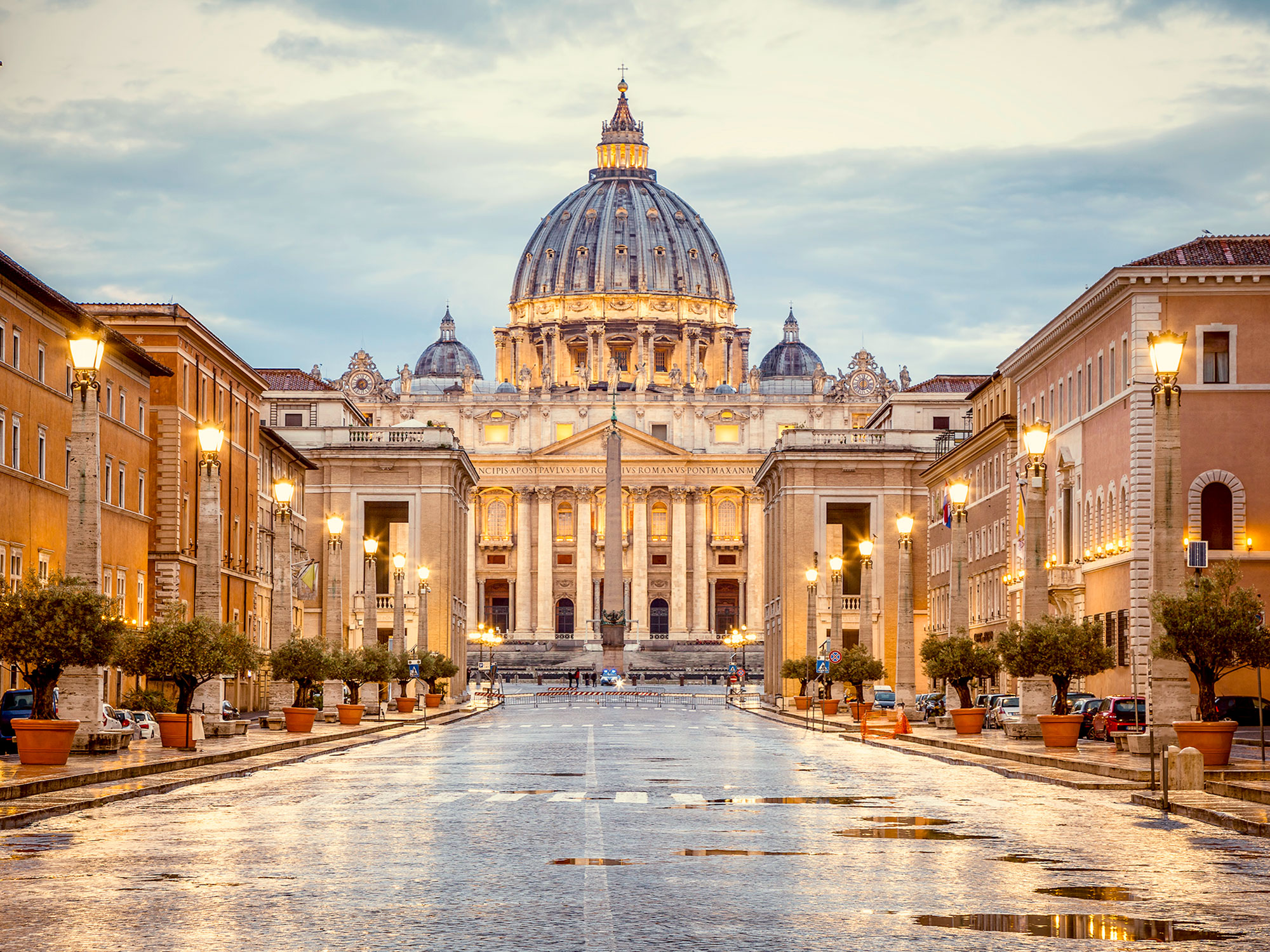View down empty street of Sistine Chapel on a rainy evening
