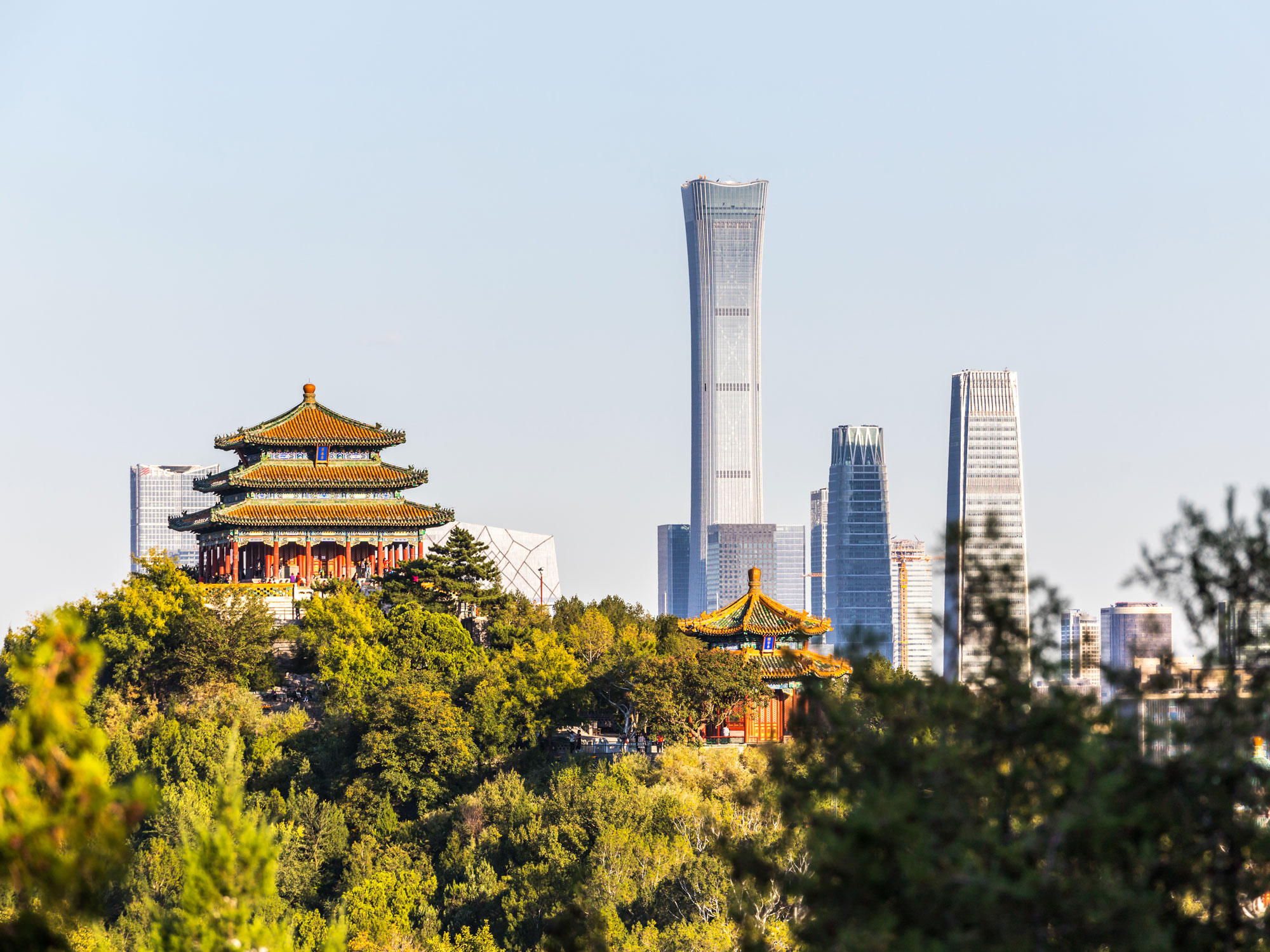 View of hilltop temple and modern Beijing skyline in the distance