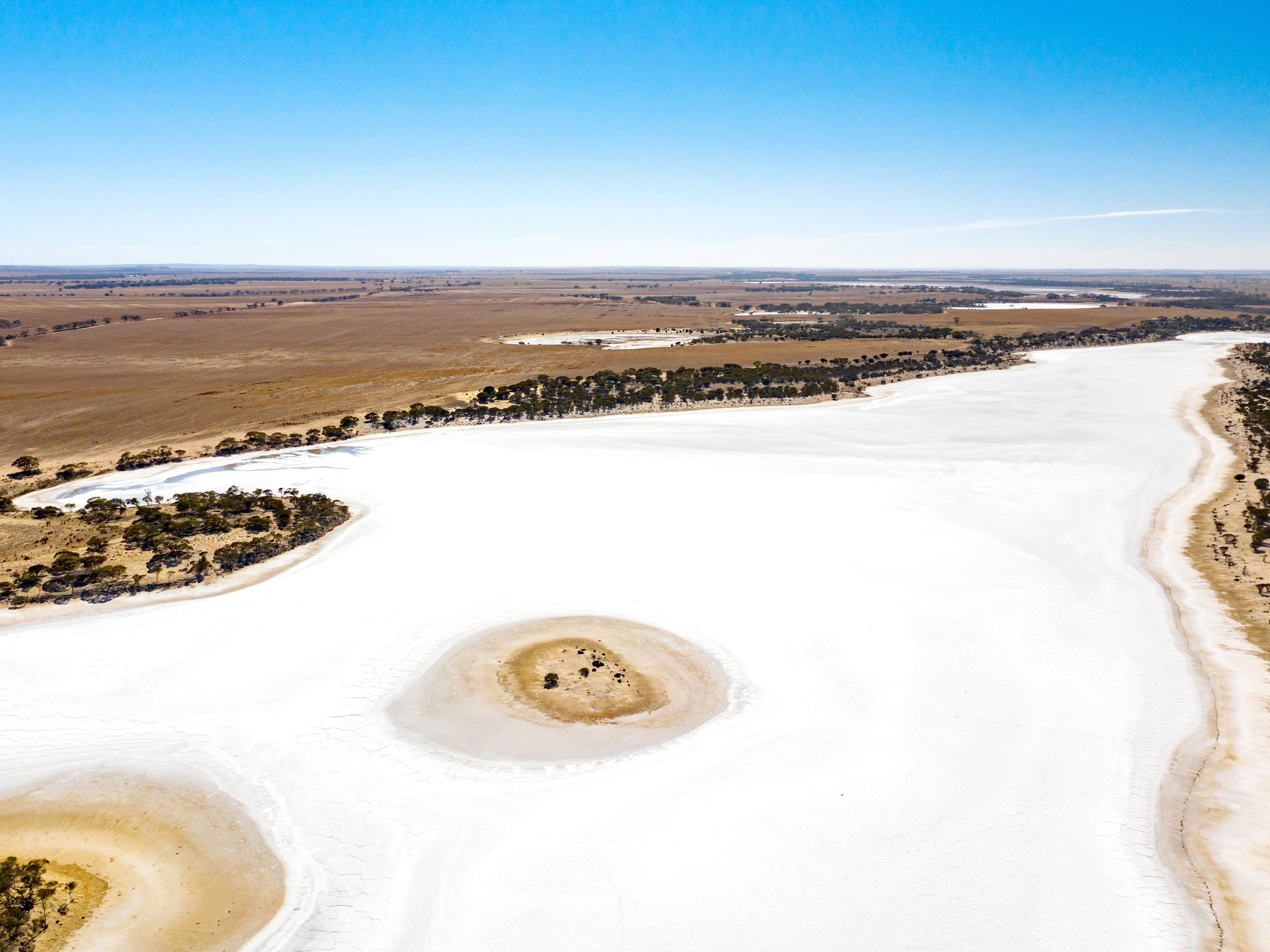 Aerial view of bright, white salty landscape of Lake Eyre in Australia