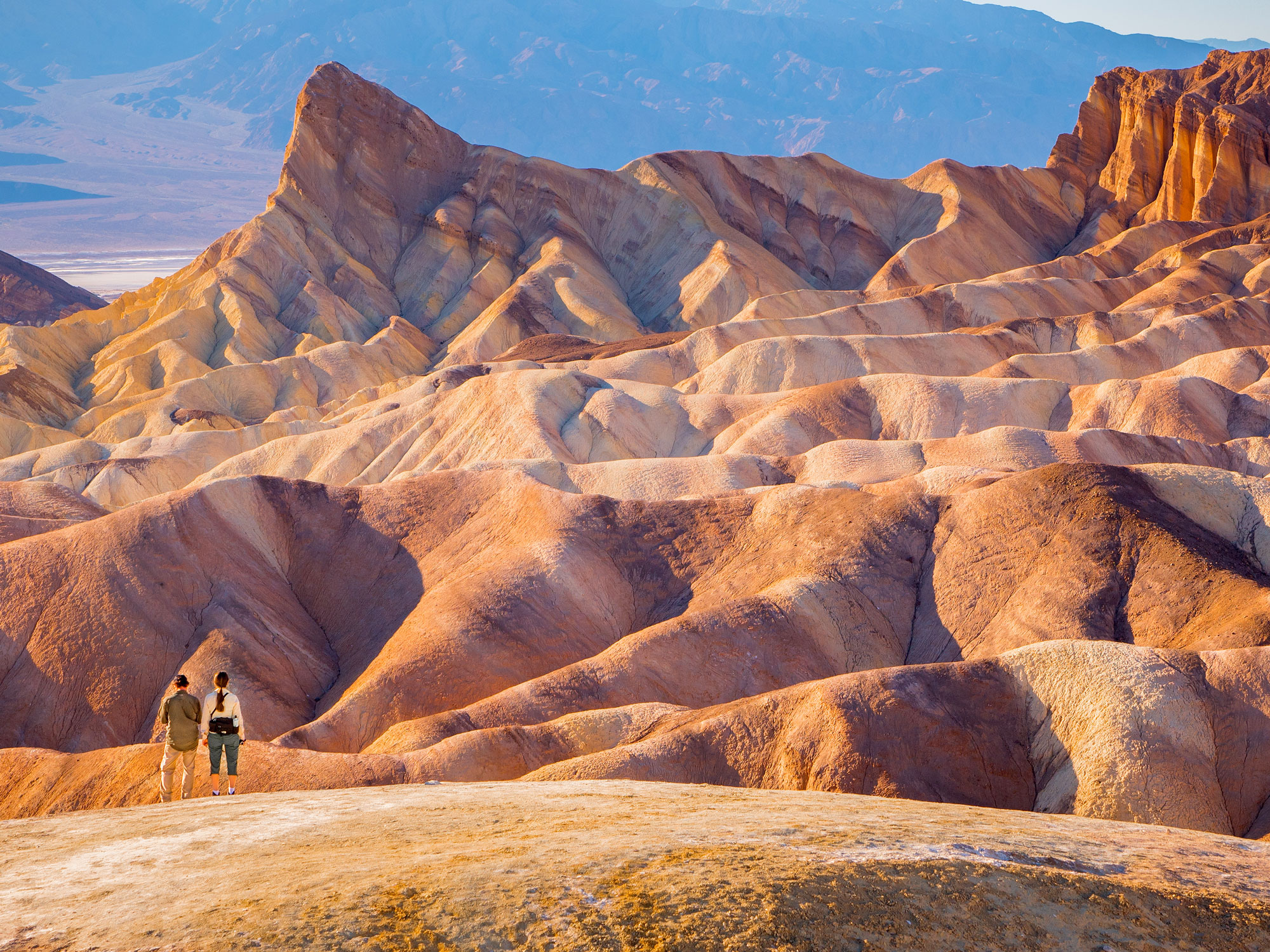People overlooking undulating desert landscape of Death Valley National Park in California