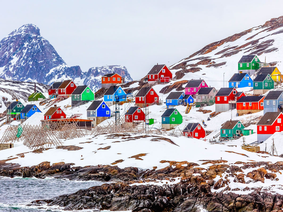 Colorful homes on snowy coastline of Greenland