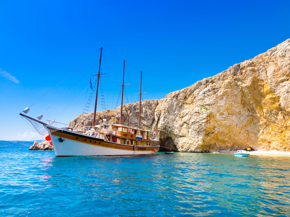Tall ship moored off the coast of rocky Croatian island