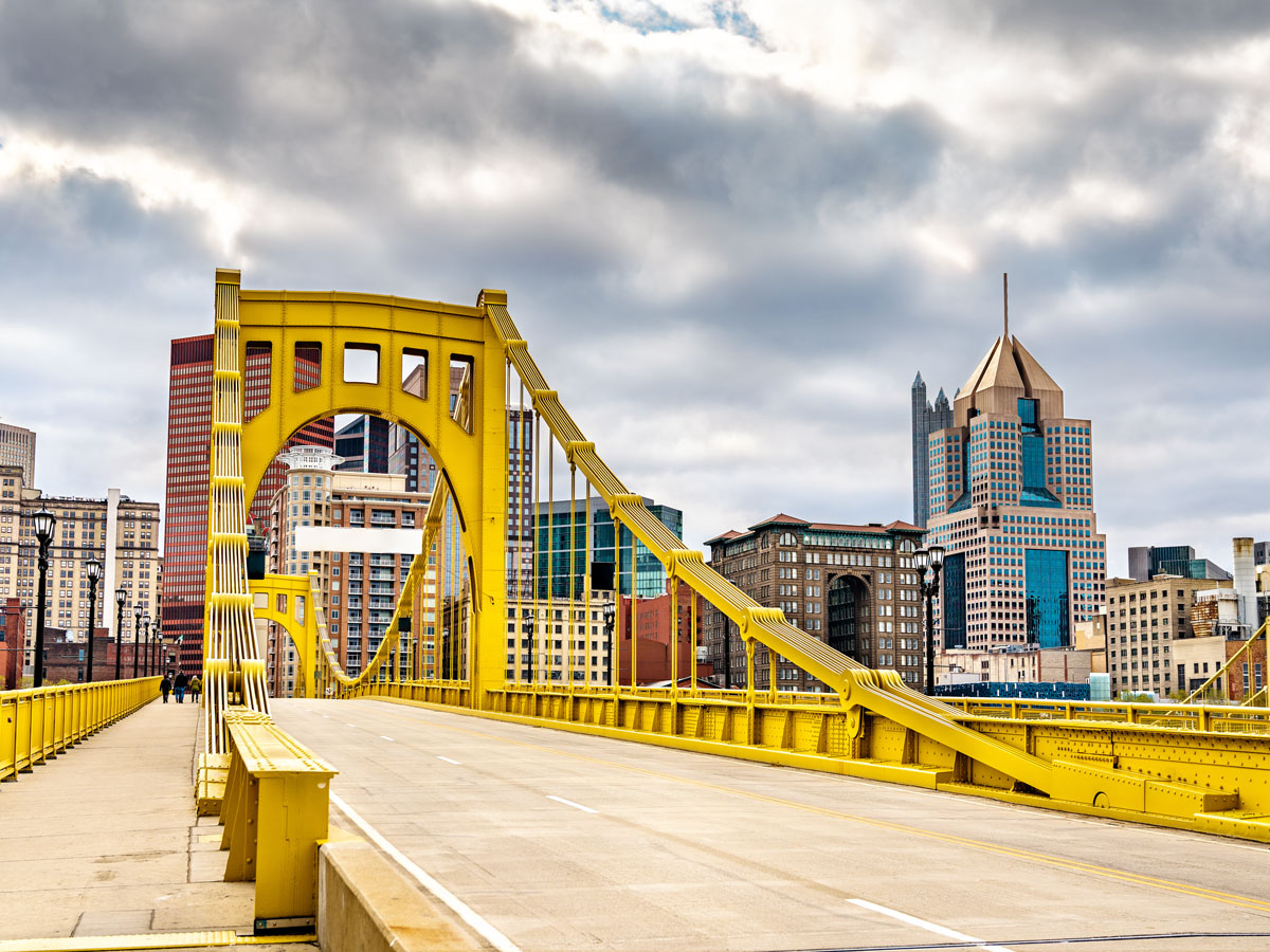 Yellow bridge leading to skyscrapers in downtown Pittsburgh, Pennsylvania