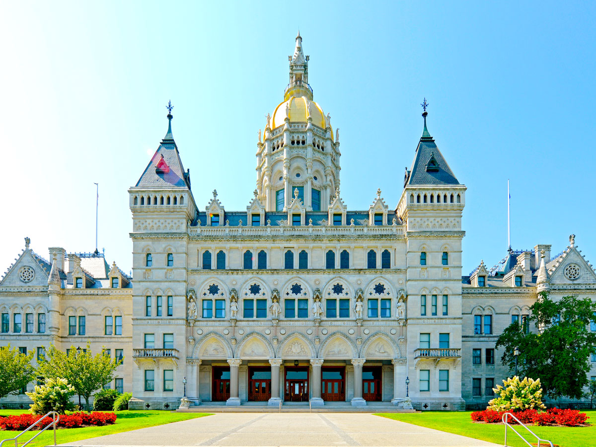 Grandiose exterior of the Connecticut State Capitol topped by gold-domed tower 