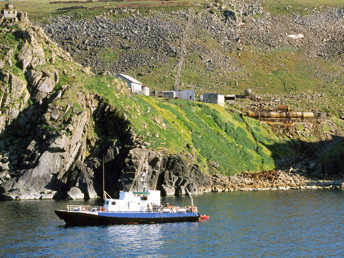 Ship off the rocky coast of the Diomede Islands