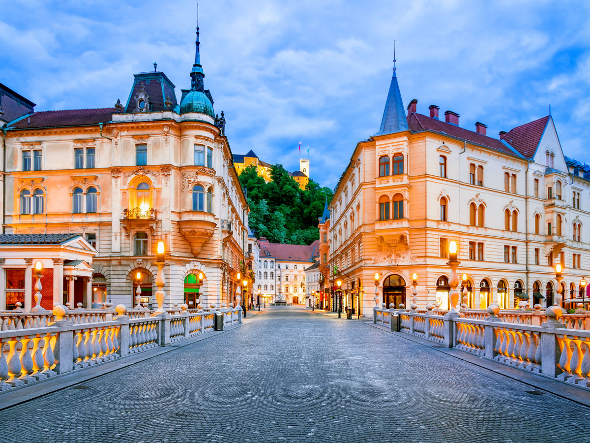Bridge in Ljubljana, Slovenia, with view of hilltop castle in the distance