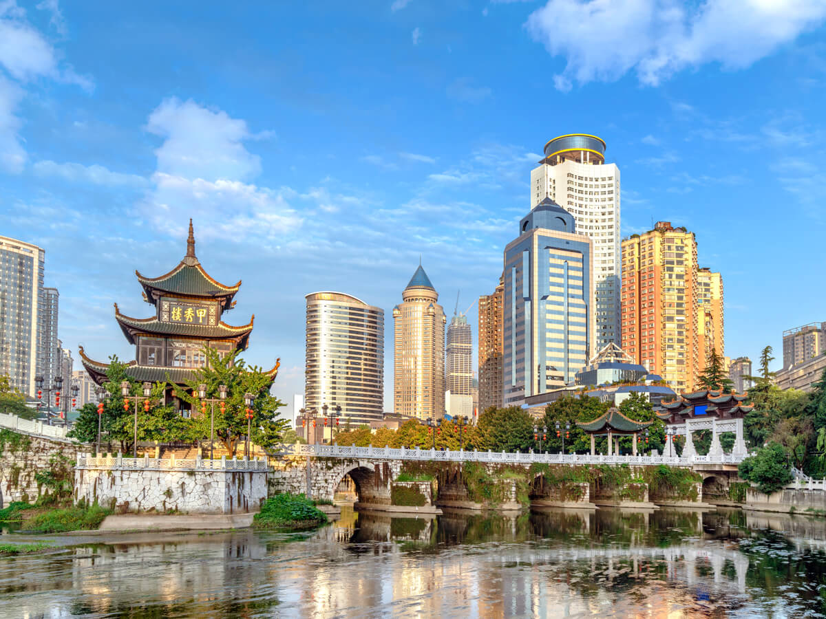 Traditional temple and modern skyscrapers, seen from across river in Guiyang, China