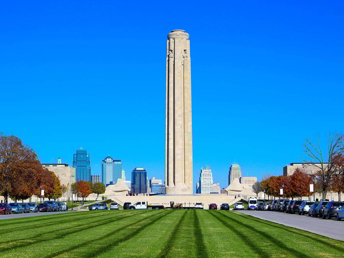 Grassy lawn in front of Liberty Memorial Tower with Kansas City skyline in background