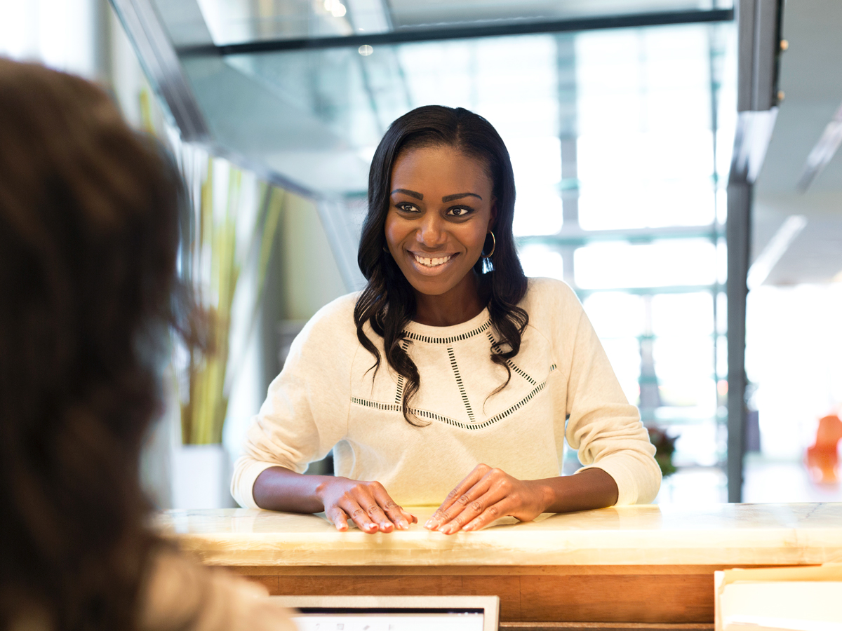 Traveler speaking to airport agent 