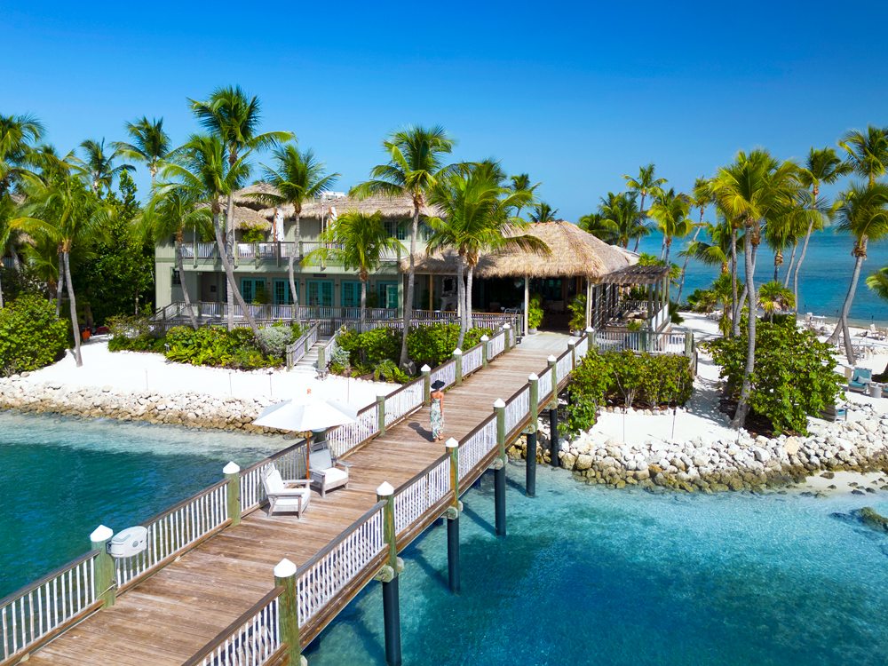 Aerial view of guest walking on pier to Little Palm Island Resort in Florida