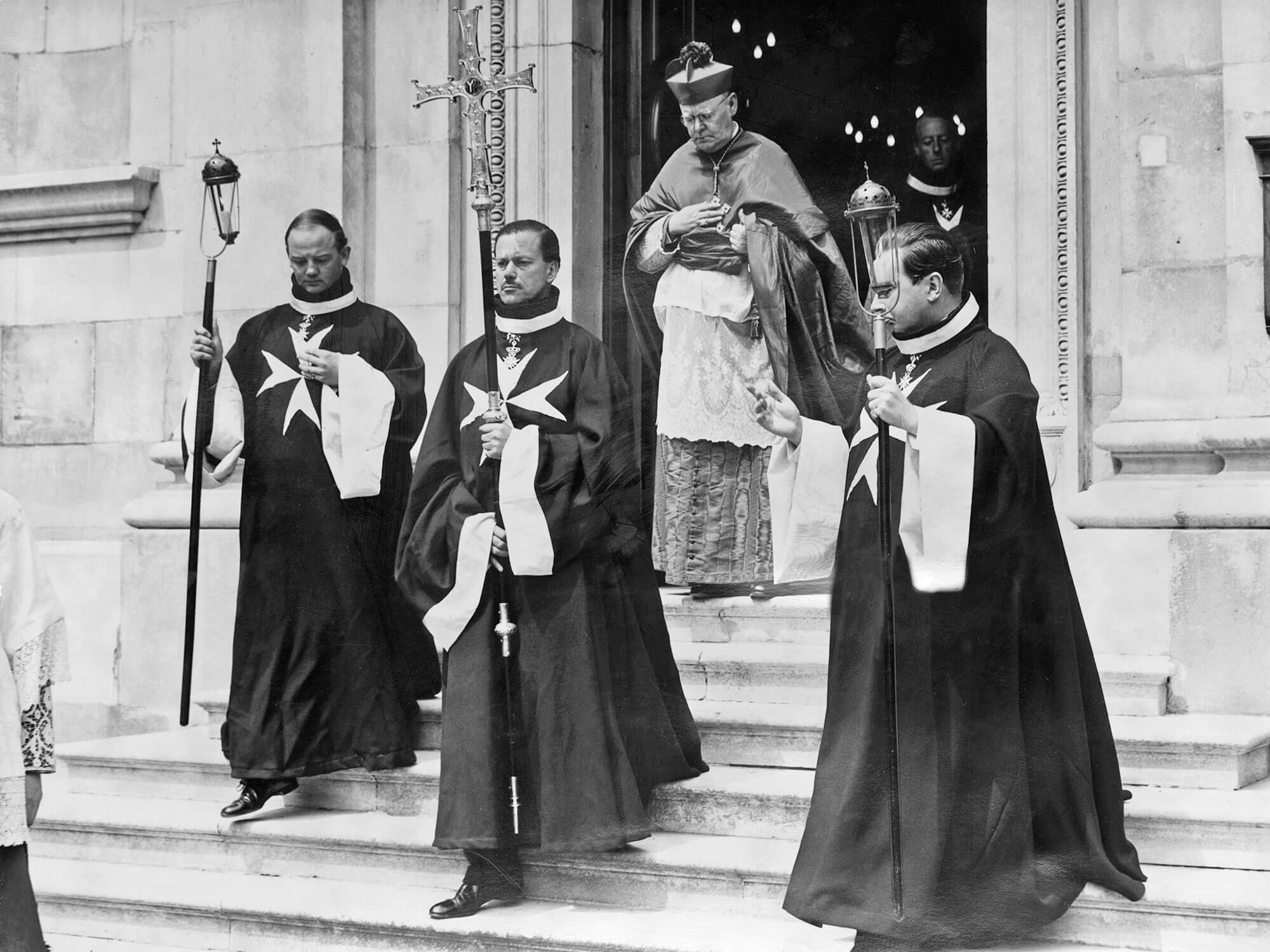 Historical photo of members of the Knights of Malta in front of church