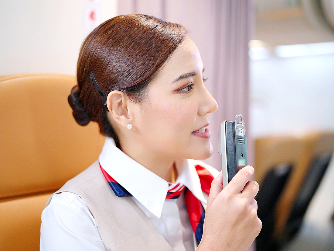 Flight attendant making announcement on PA