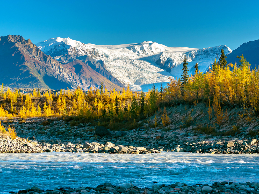River, forest, and snow-capped mountain peaks in Wrangell-St. Elias National Park and Preserve, Alaska