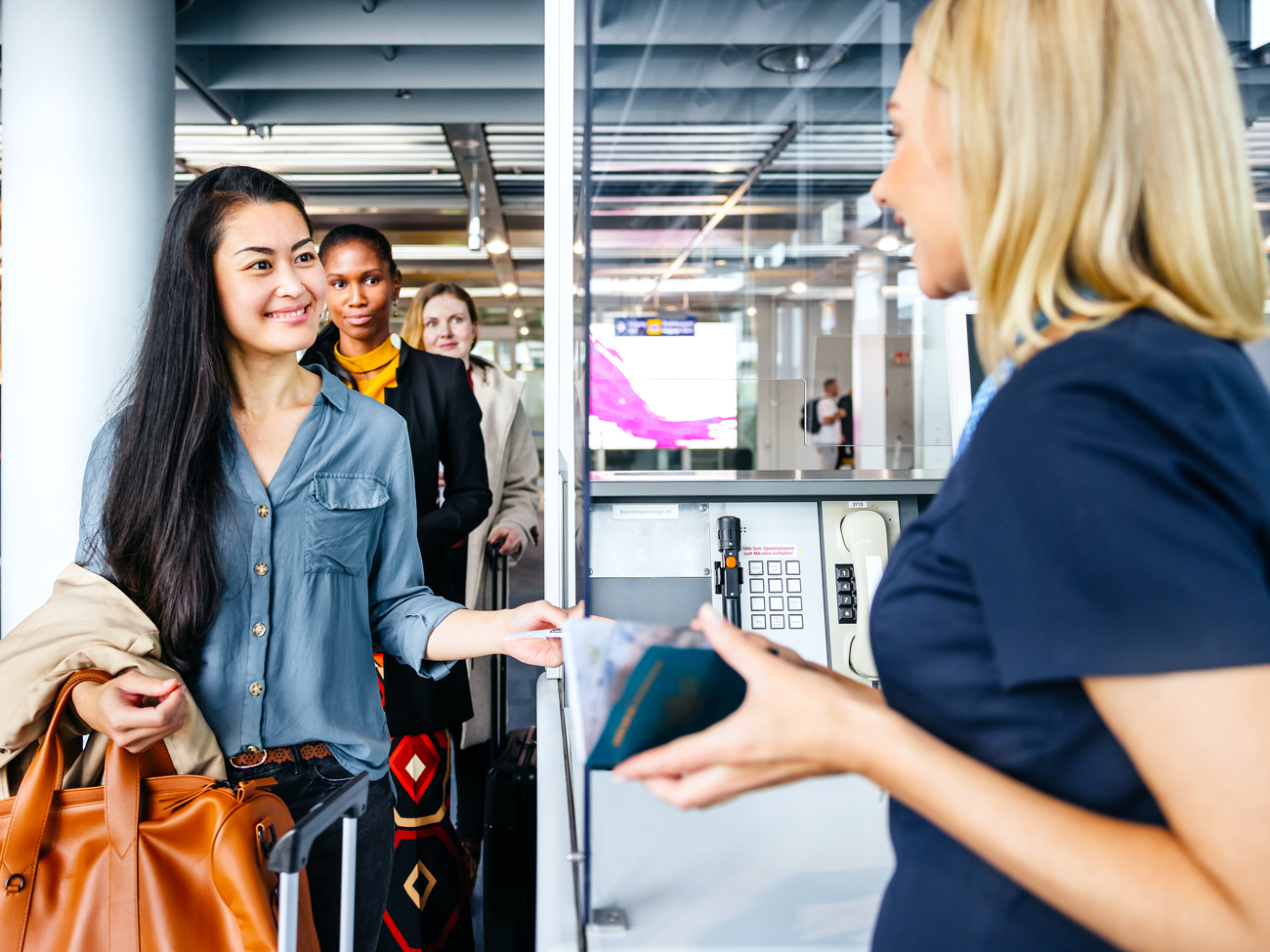 Passenger handing identification to airport agent