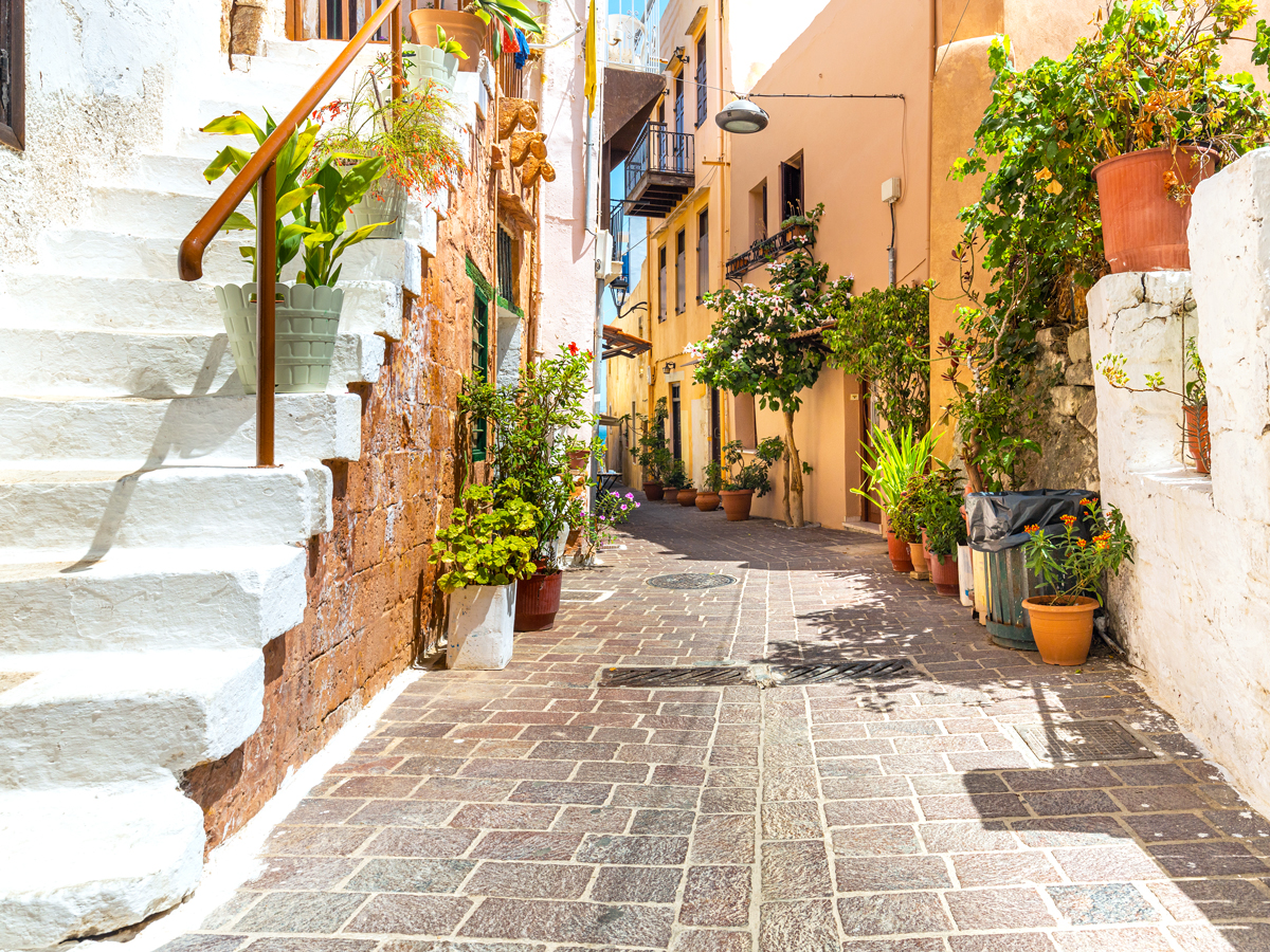 Narrow stone street between homes on island of Crete, Greece