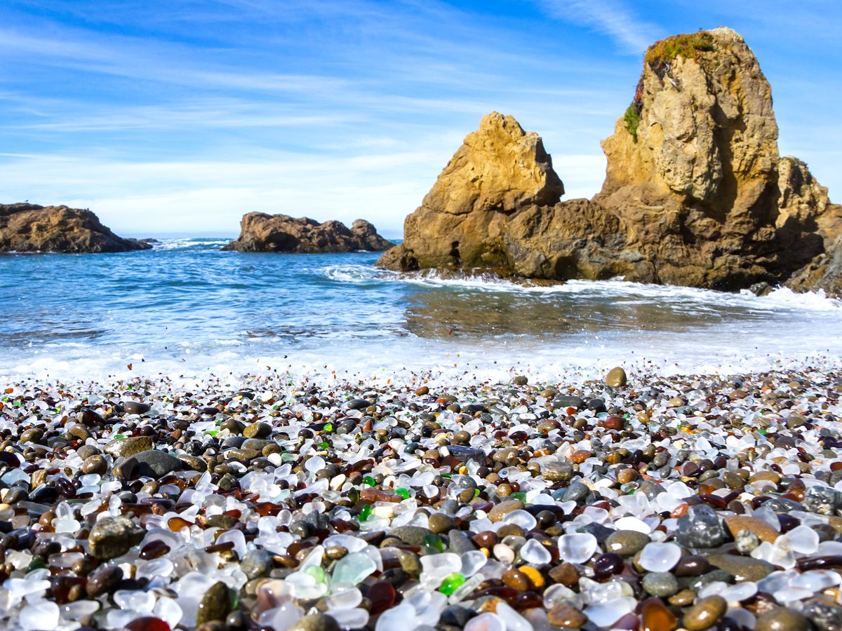 Small glass stones covering Glass Beach in California