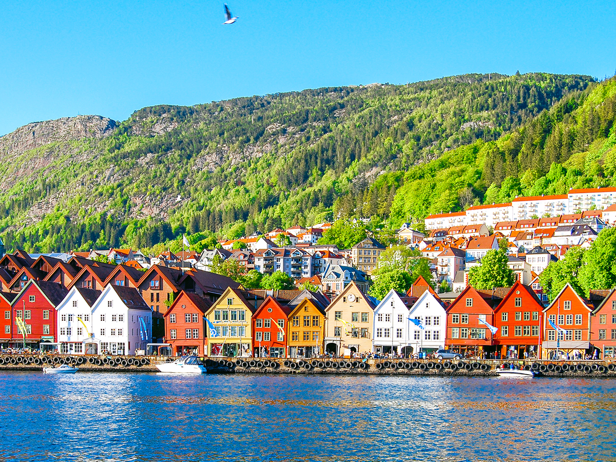 Colorful waterfront buildings with mountain in background in Bergen, Norway