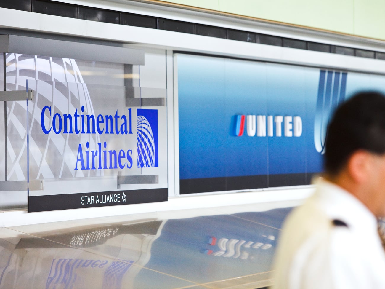 Continental and United Airlines signage at airport check-in counter