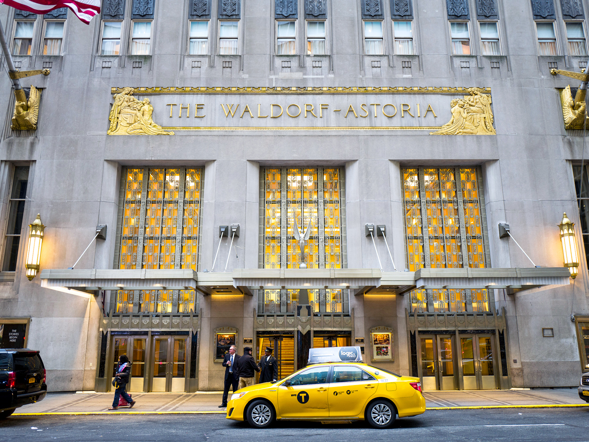 Yellow taxi parked outside Waldorf Astoria hotel in New York City