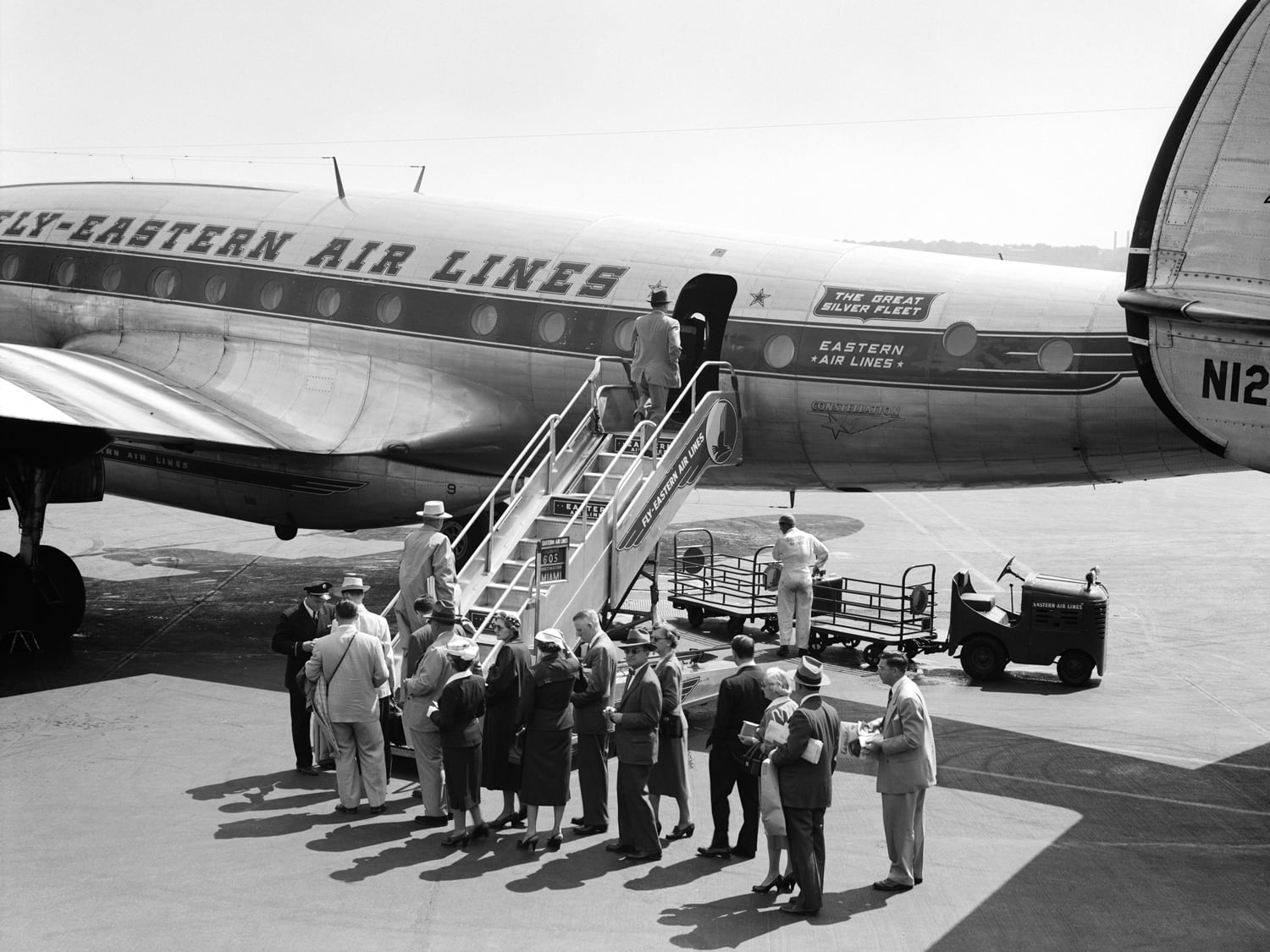 Historical images of passengers boarding Eastern Airlines aircraft via air stairs