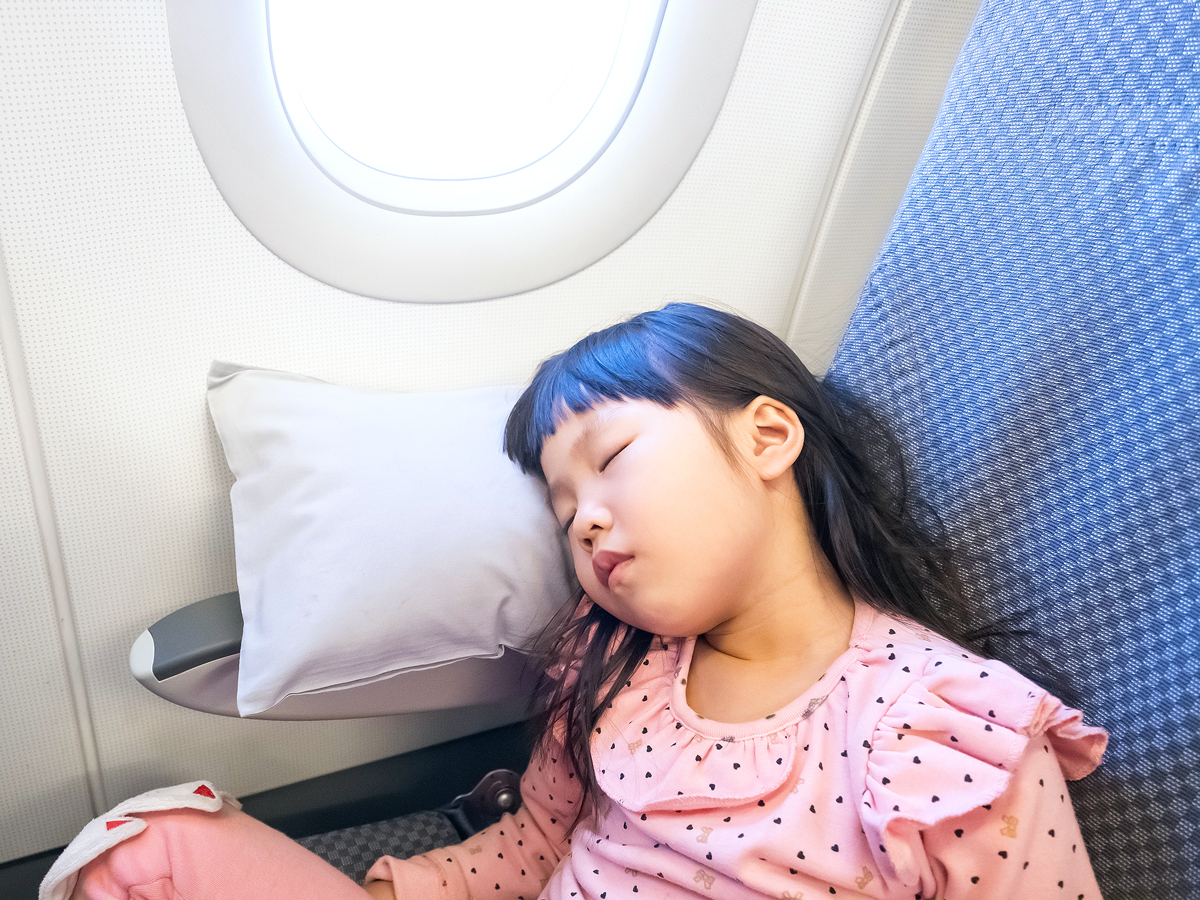 Child sleeping in airplane seat
