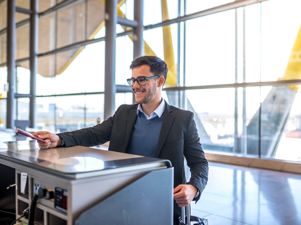 Airline passenger handing ID to agent at airport