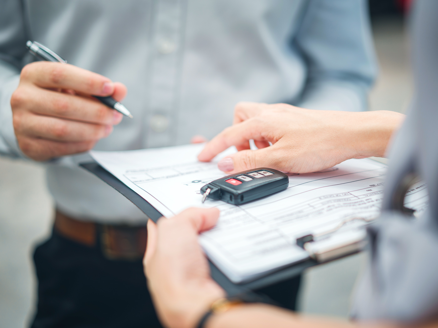 Car rental customer signing rental agreement
