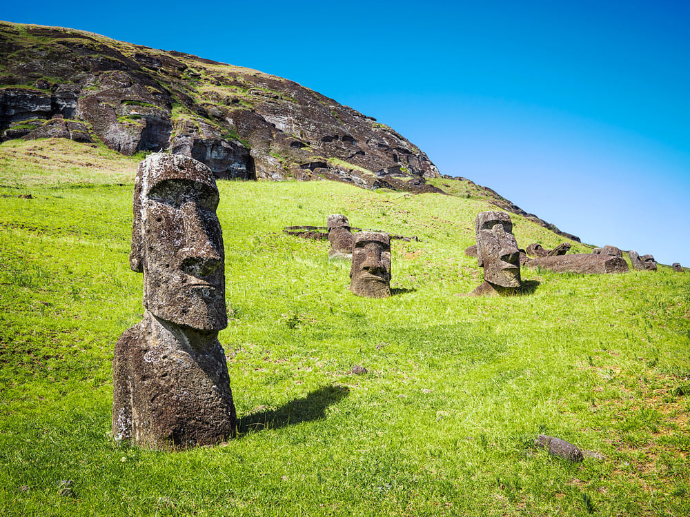 Moai statues half-buried in hillside on Easter Island
