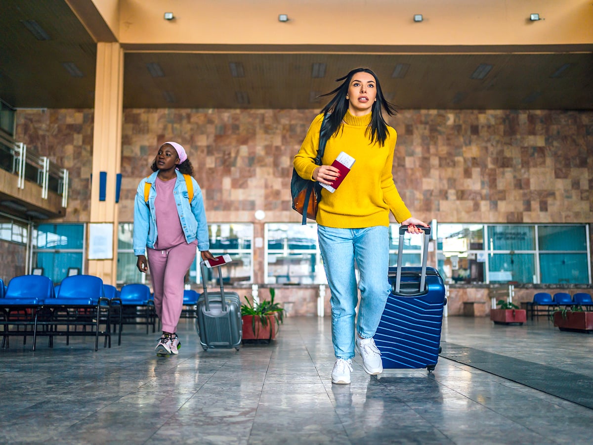 Passengers walking through airport with luggage