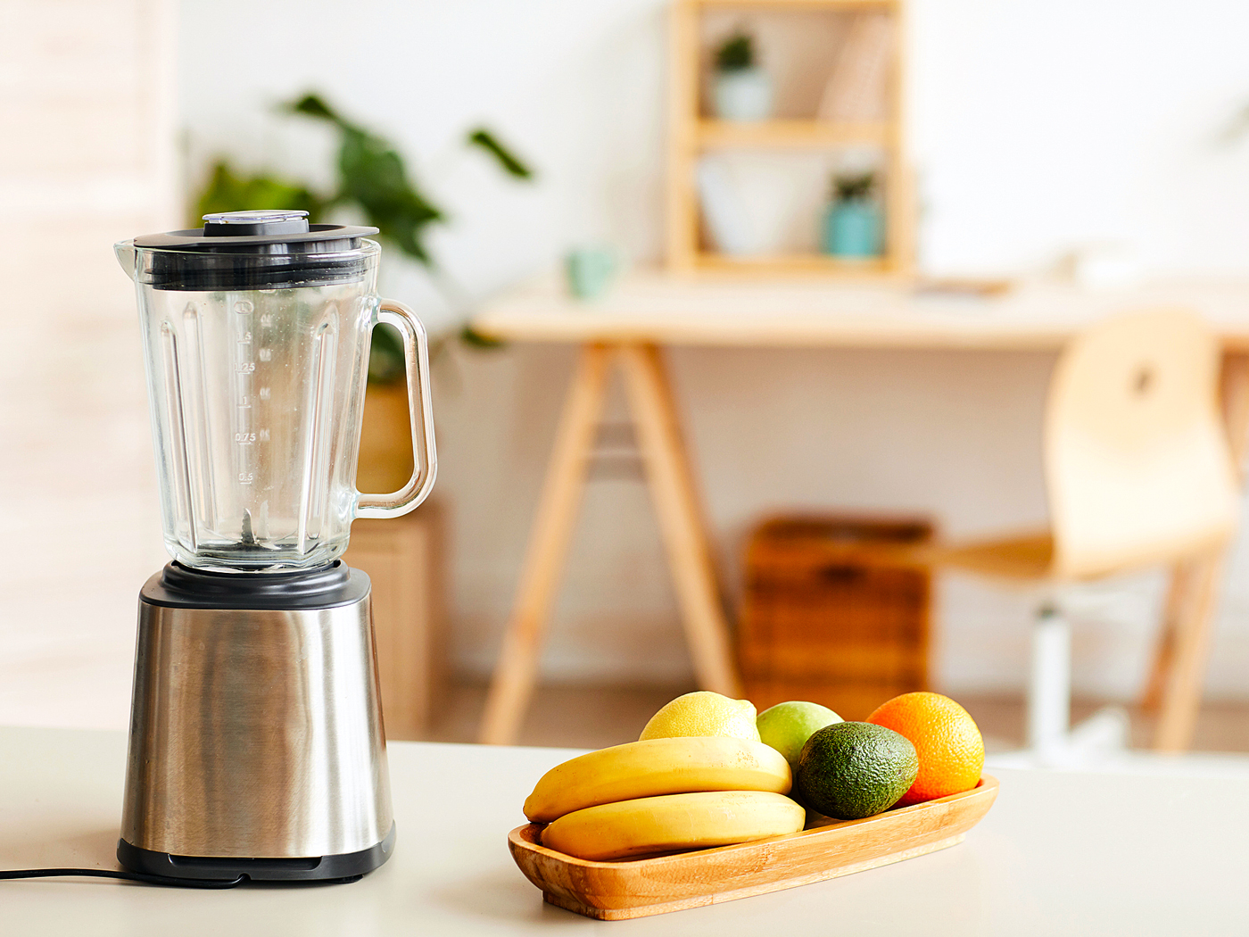 Fruit and blender sitting on counter