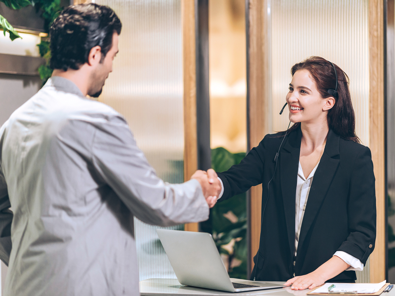 Hotel guest shaking hands with staff