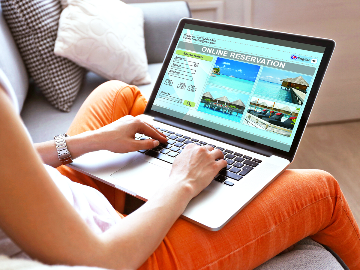 Traveler booking reservation on laptop
