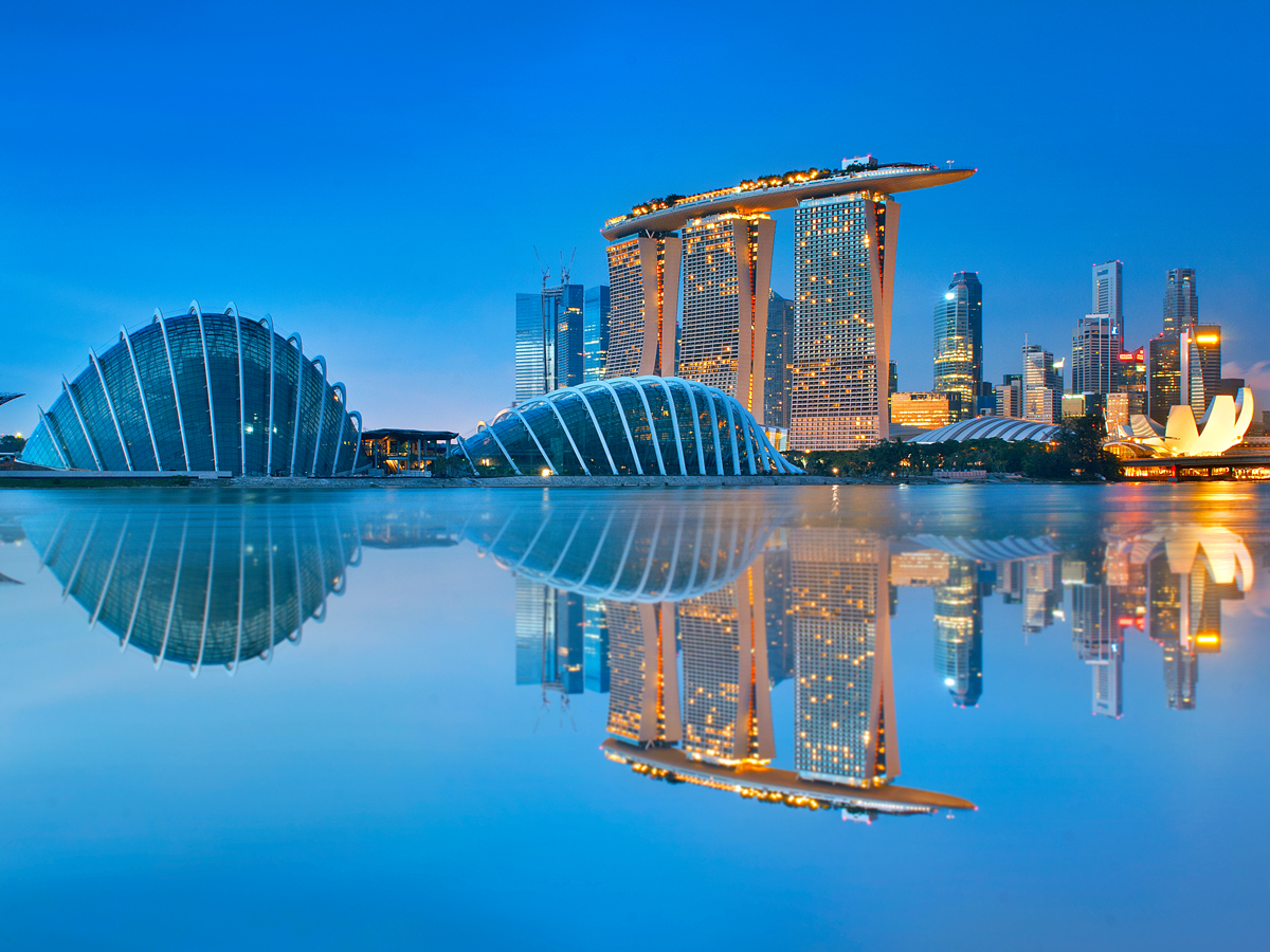 Skyline of Singapore reflecting on bay at night