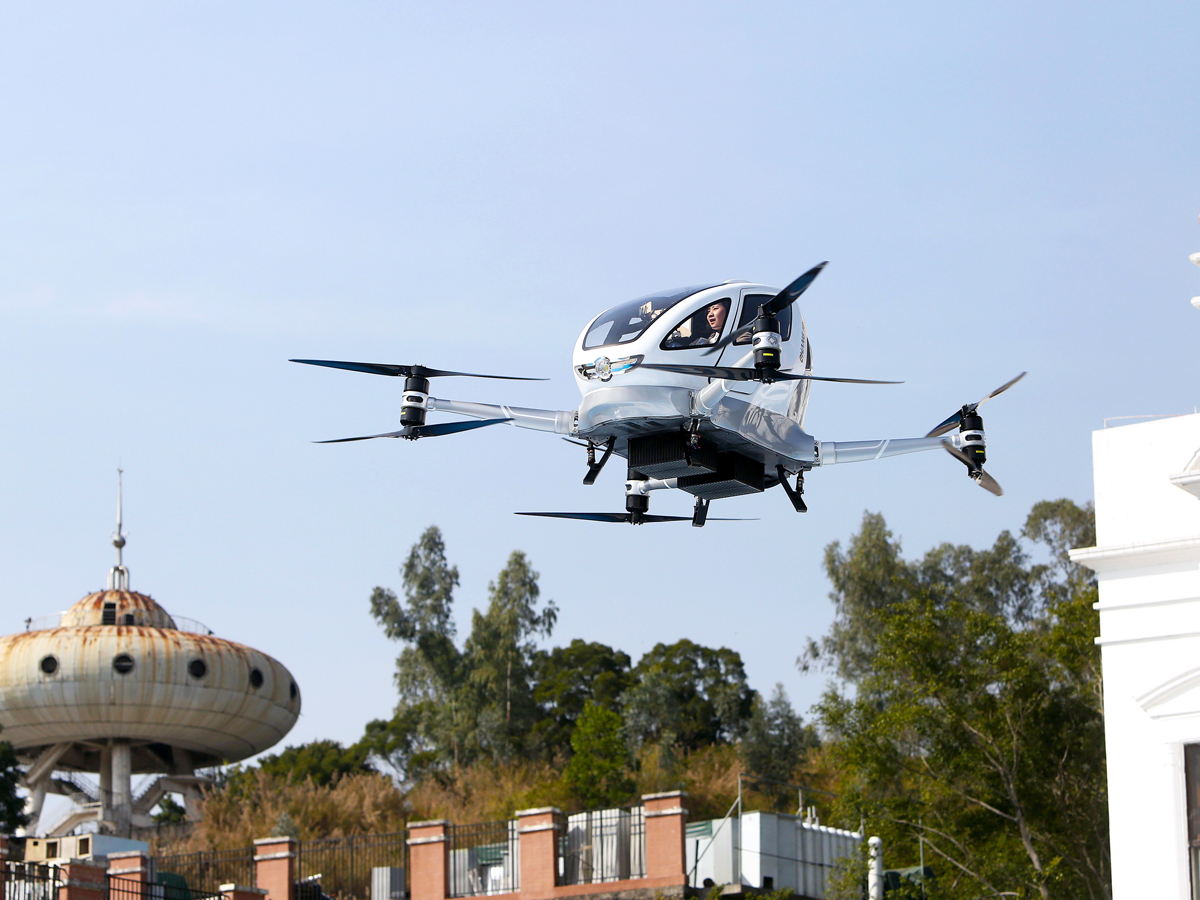 EHang passenger drone prototype hovering above buildings