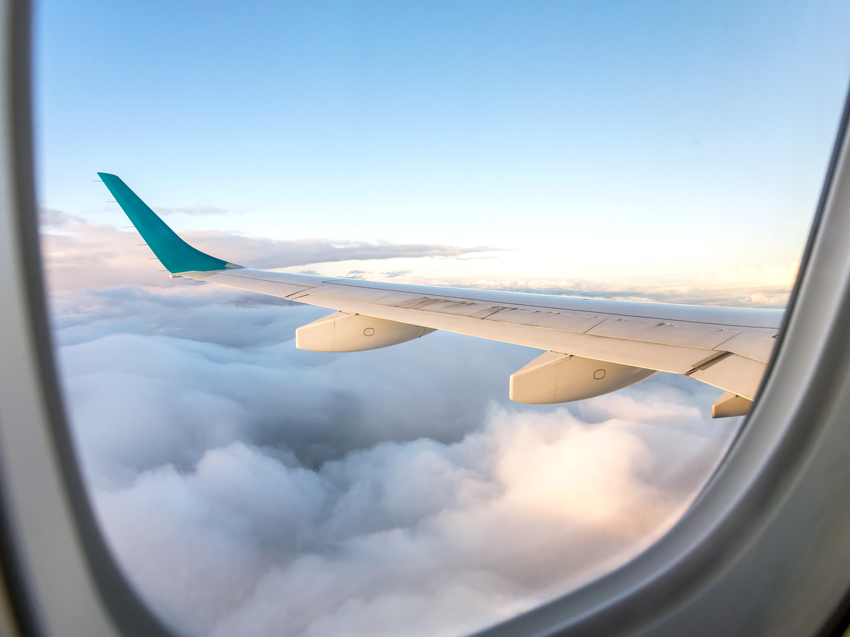 View of airplane wing out passenger window during flight