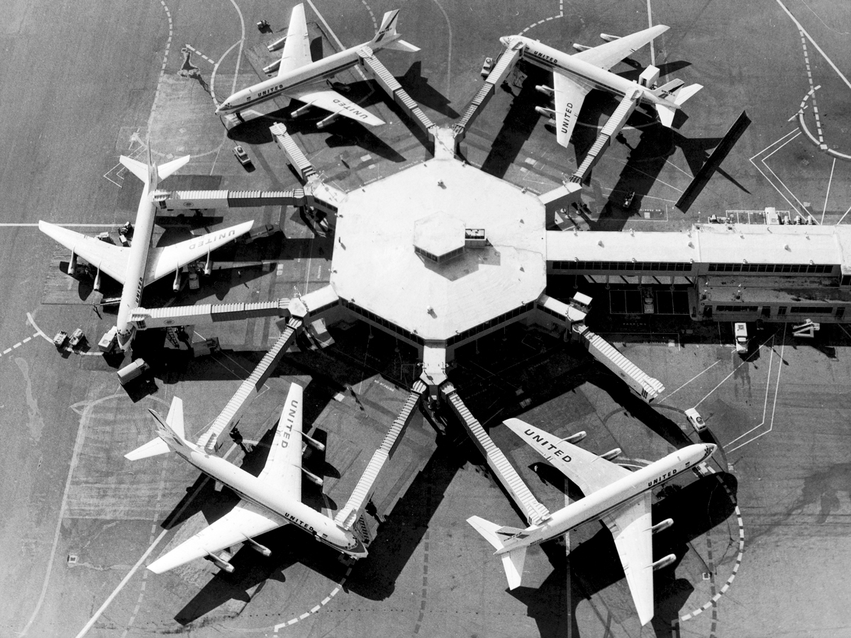 Aerial view of jets parked at gates at San Francisco International Airport circa 1965