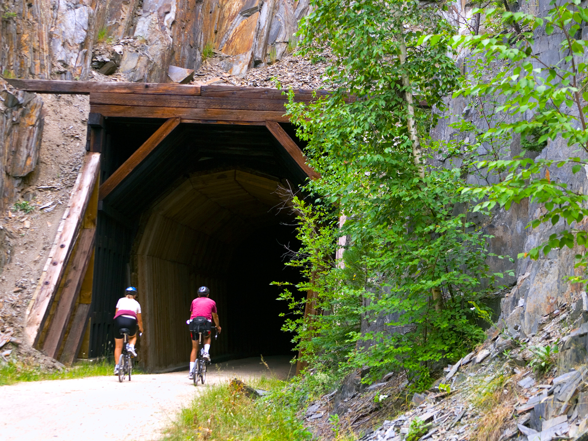 Two bikers entering tunnel on the George S. Mickelson Trail in South Dakota