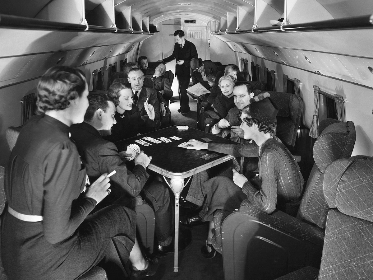 Passengers playing cards in flight during the 1930s
