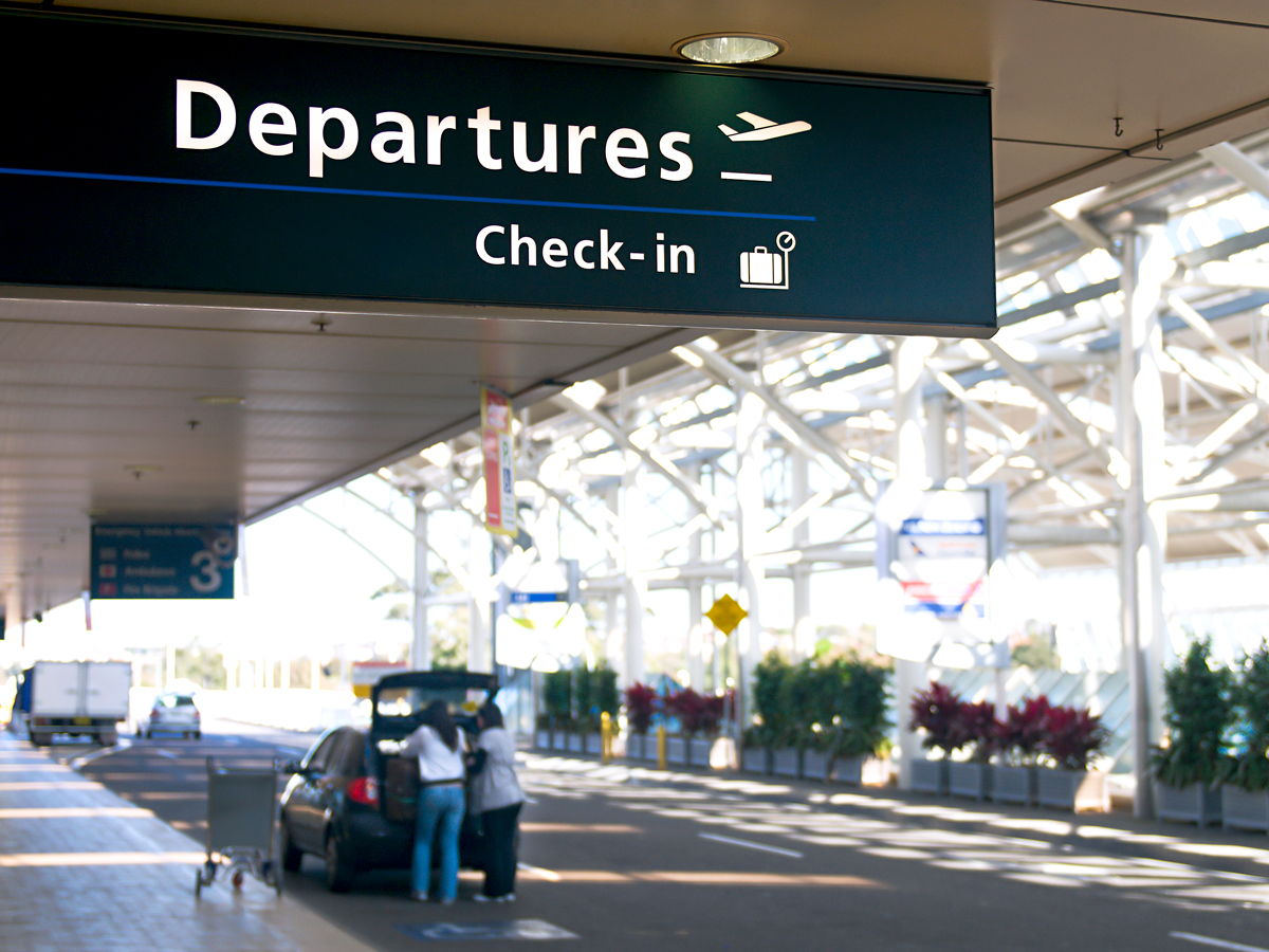 Curbside sign for departures and check-in at airport