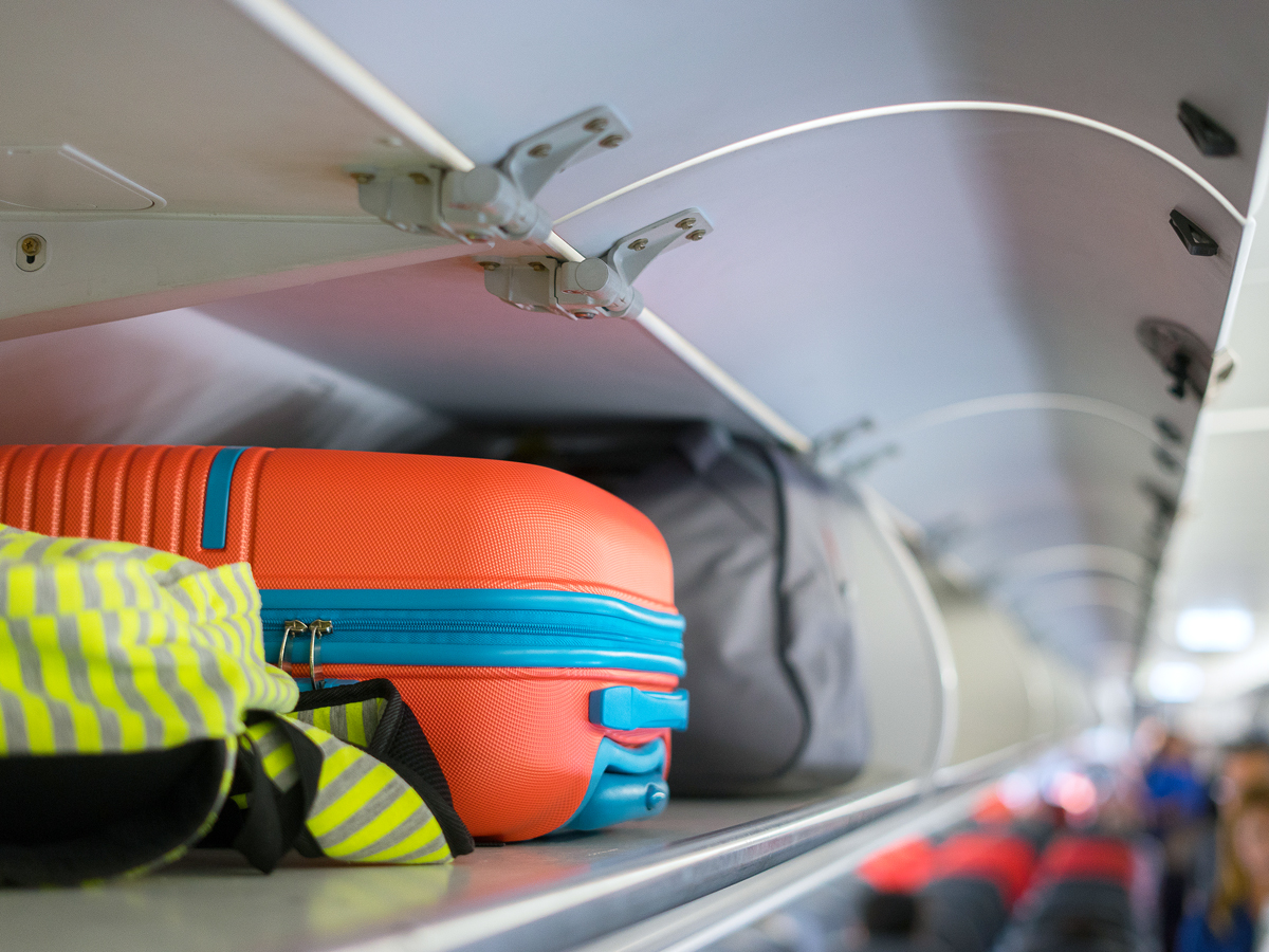 Close-up image of baggage in airplane overhead bin