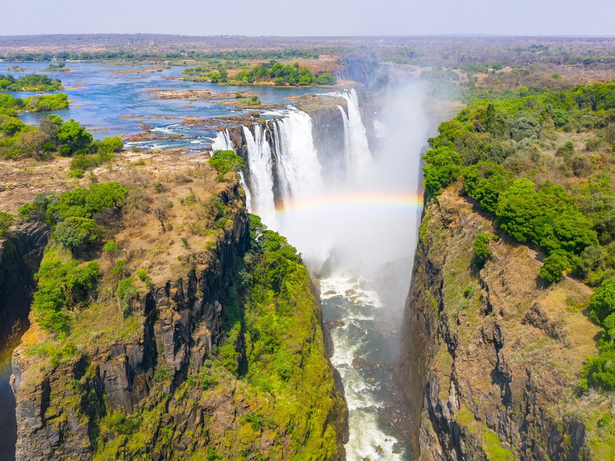 Aerial view of rainbow over Victoria Falls, on the border of Zambia and Zimbabwe
