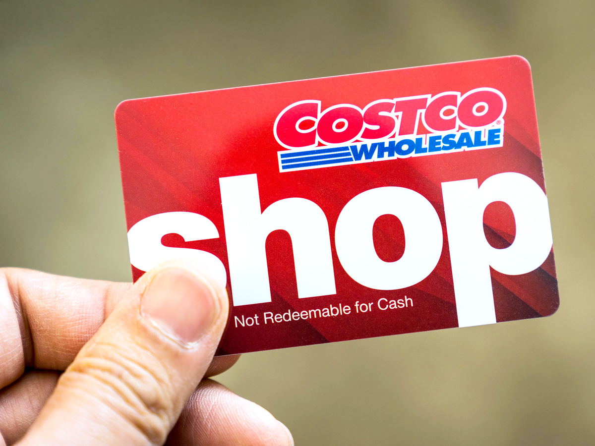 Close-up image of person holding Costco membership card