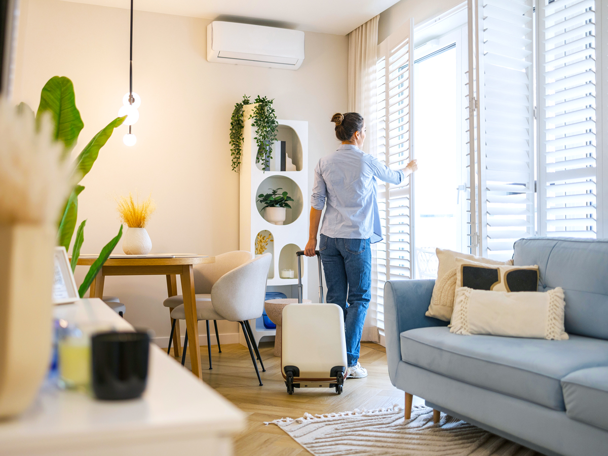 Traveler with suitcase returning home