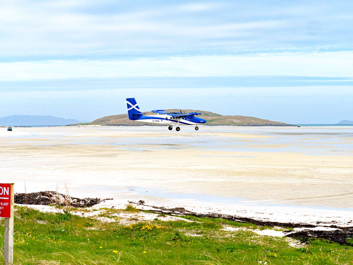 Aircraft landing on beach runway at Barra Airport, Scotland