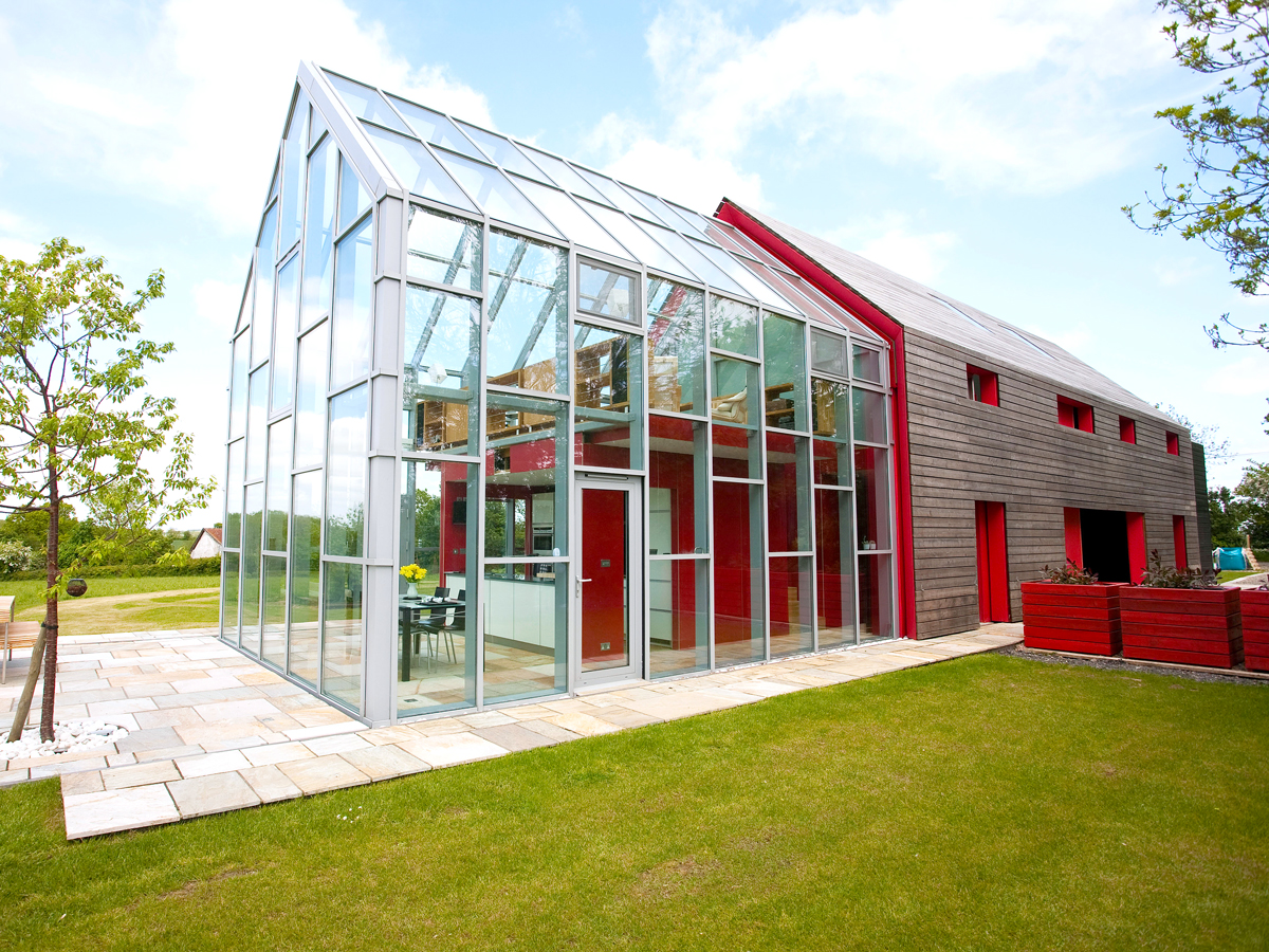 Glass-clad exterior of the Sliding House in Suffolk, England