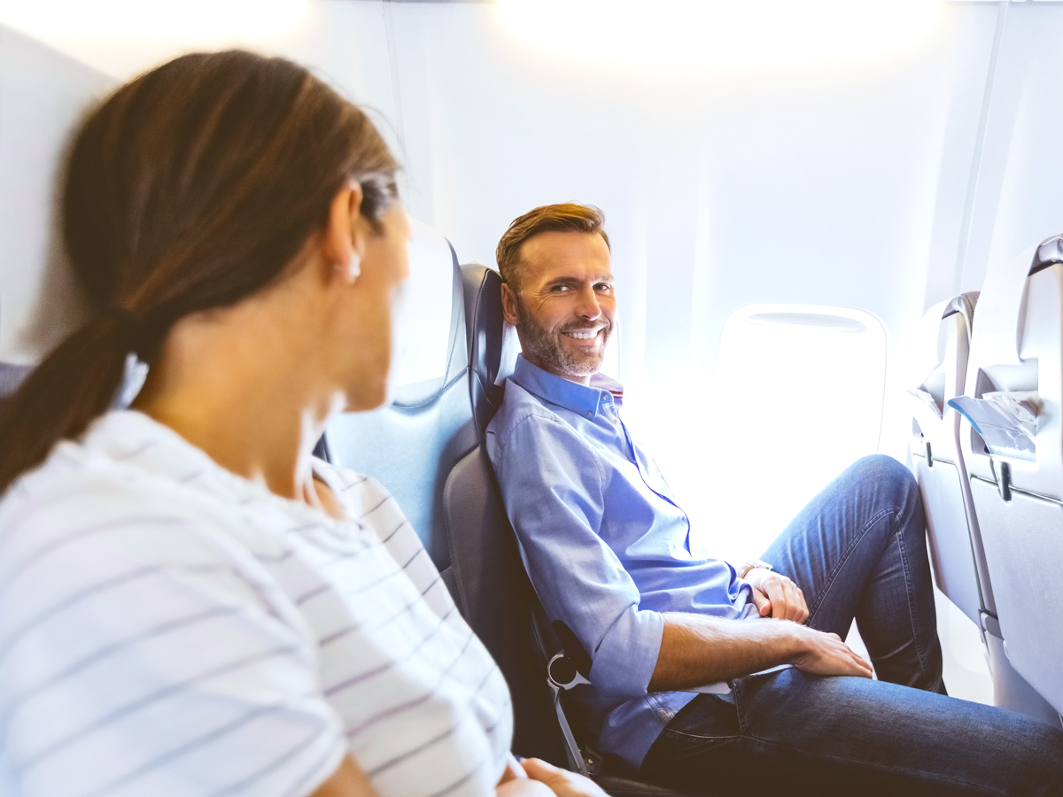 Passengers conversing on airplane