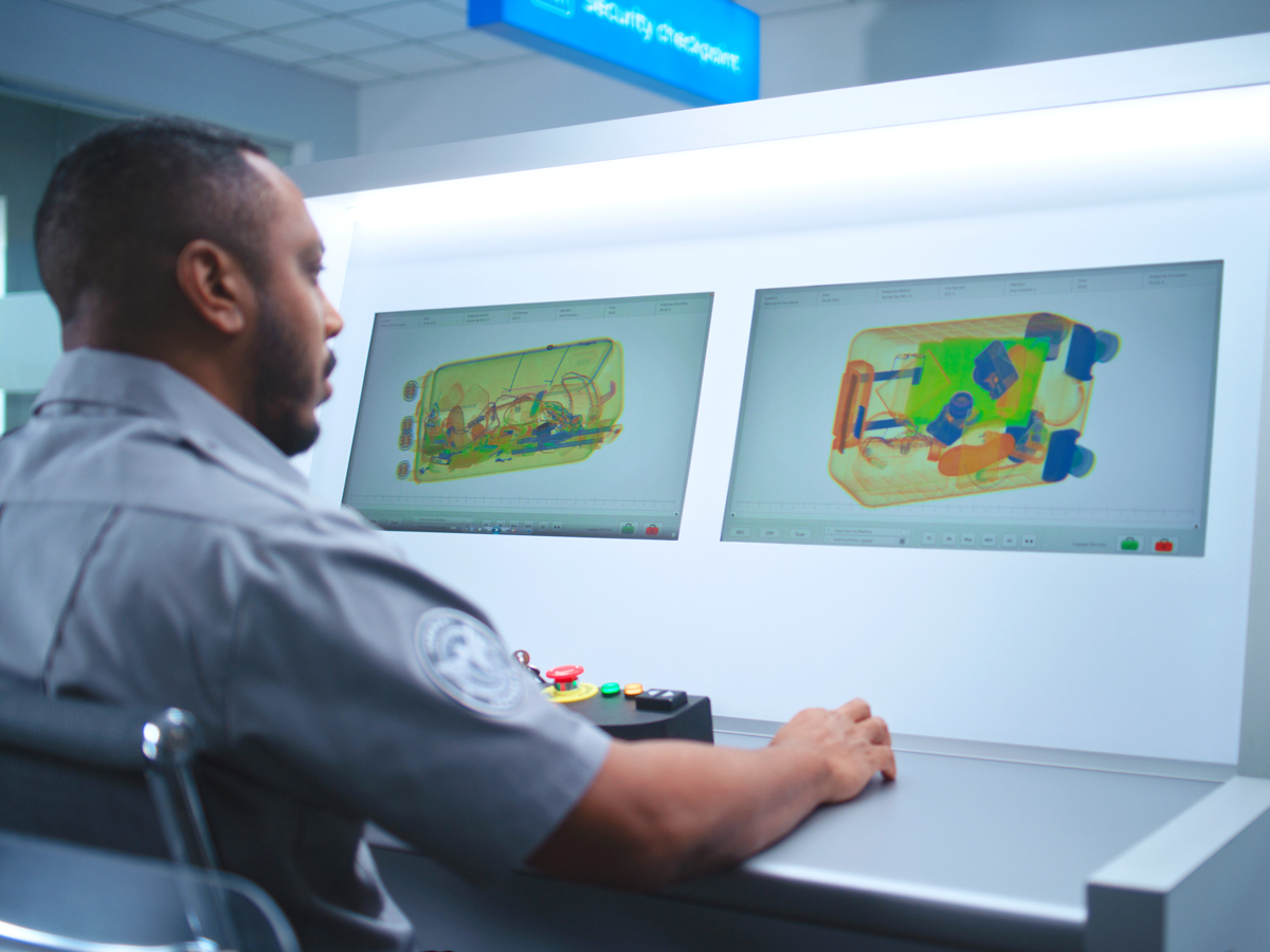 Airport security officer reviewing X-ray images of luggage