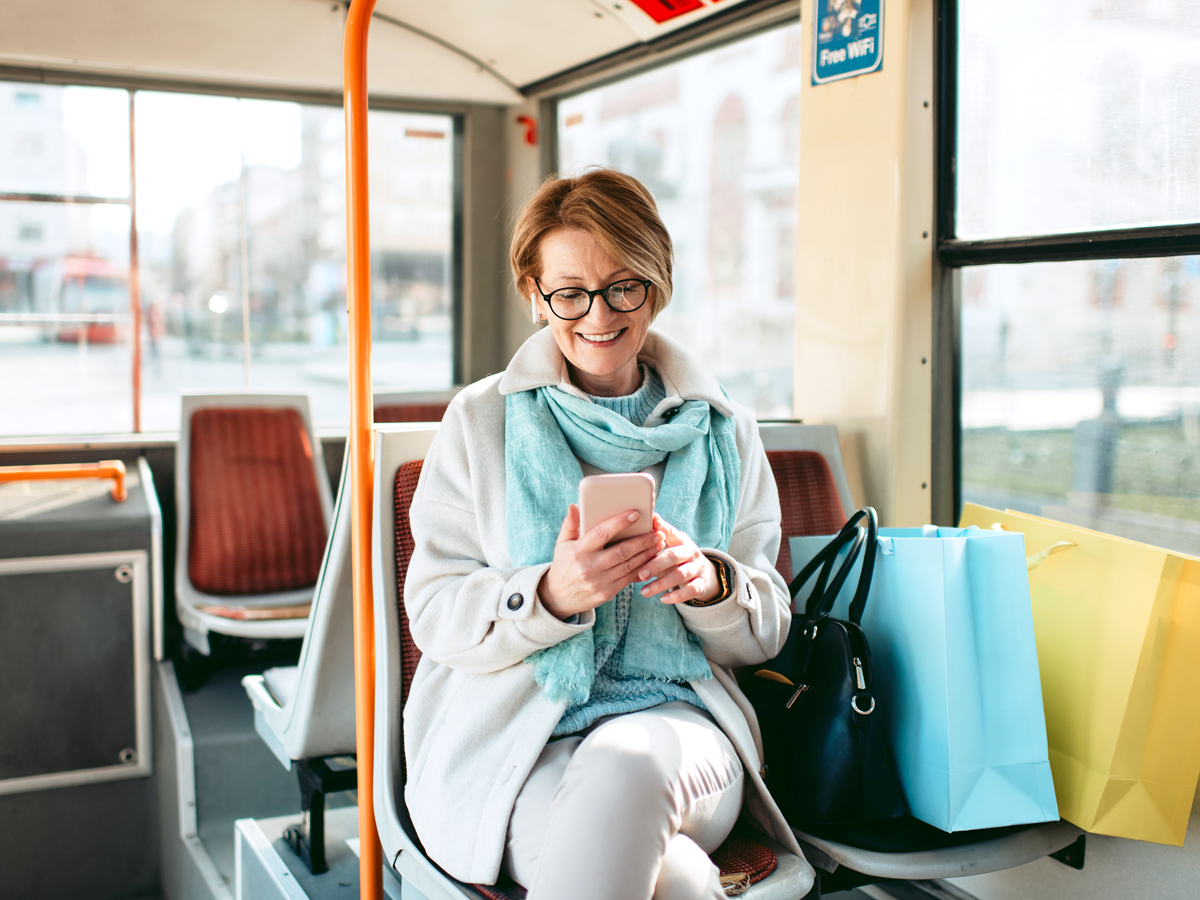 Woman looking at phone while riding bus