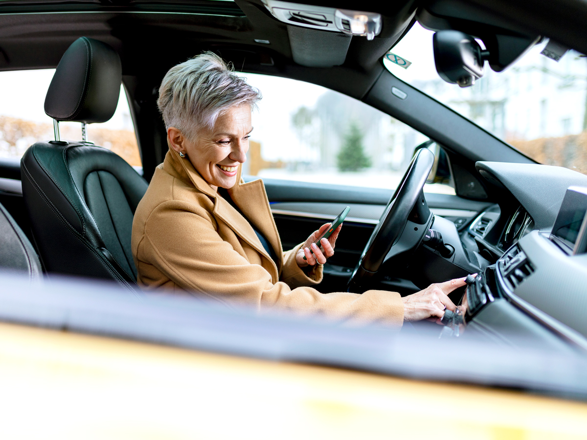 Woman using stereo in car