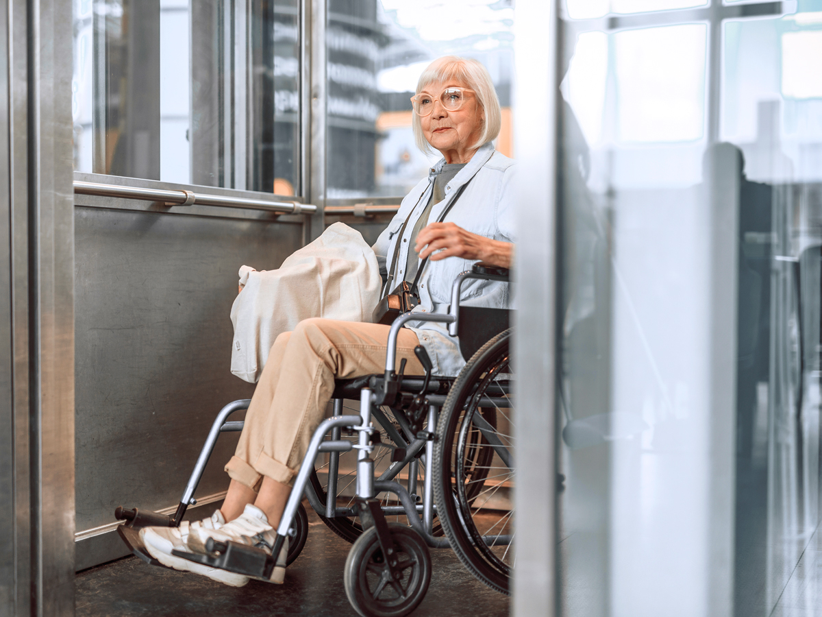 Traveler in wheelchair using elevator